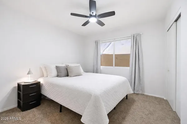 a bedroom with a bed and window