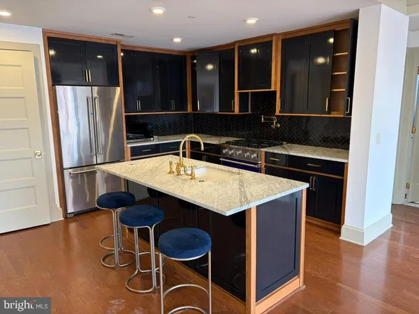 a kitchen with a sink and a refrigerator