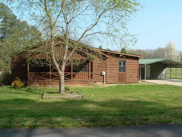 1352 Rush Chapel Road Northeast Rome, GA 30161 - Photo 1 of 1 a view of a backyard with a garden