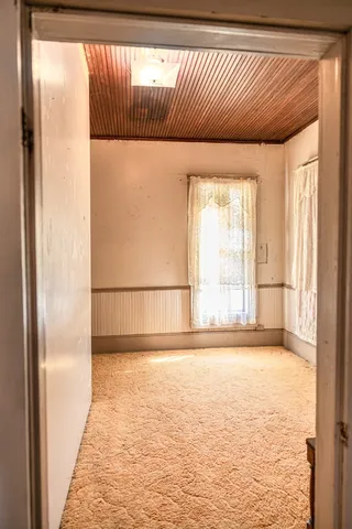 a living room with furniture a ceiling fan and a large window