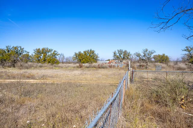 a view of a house with a yard covered in snow