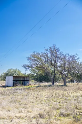 a view of dirt road with a building in the background