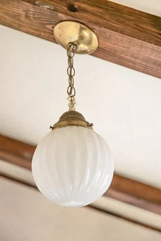 an empty room with windows and ceiling fan