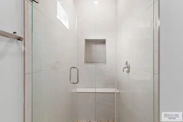 a bathroom with a glass shower door