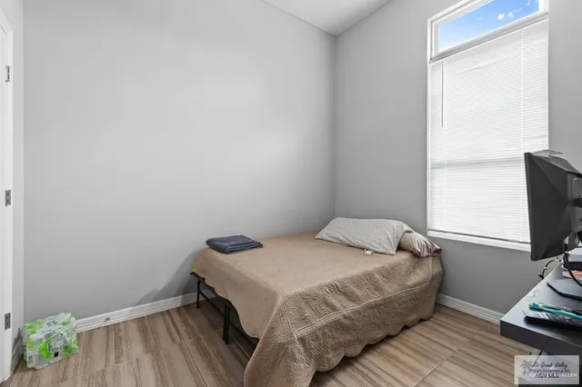 a bedroom with a bed and flat screen tv