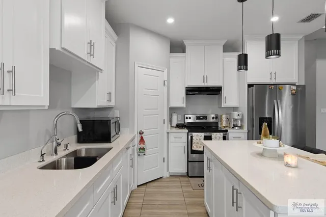 a kitchen with a sink stove and refrigerator