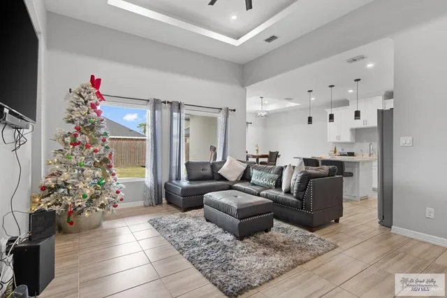 a living room with furniture and a chandelier