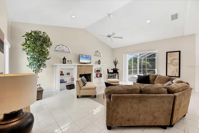 a living room with furniture cabinets and a large window