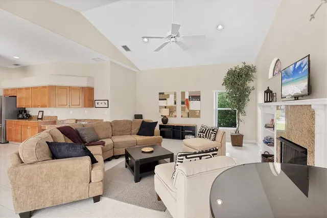 a living room with furniture a fireplace and a flat screen tv