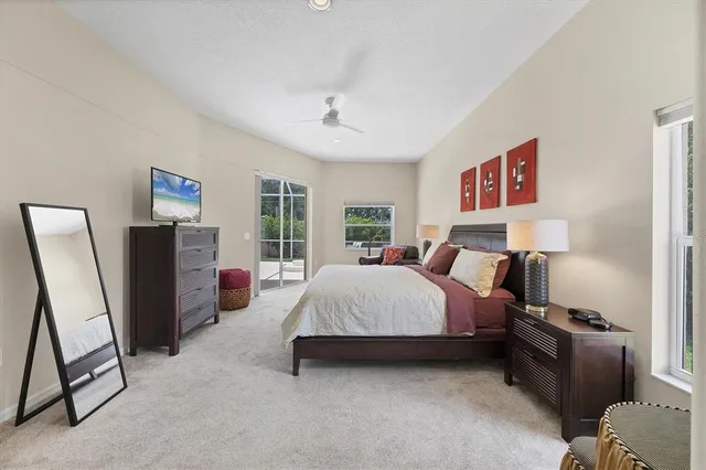 a spacious bedroom with a bed and dresser