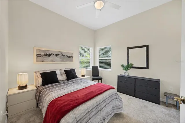 a bedroom with a large bed and a window