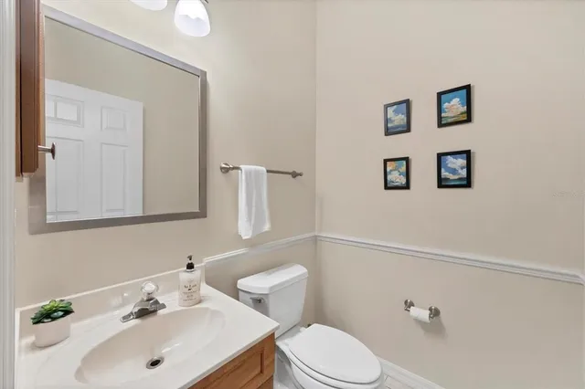 a bathroom with a sink mirror and toilet