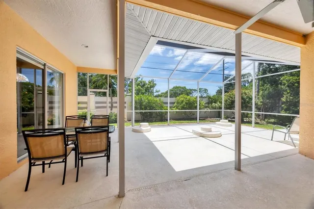 a view of a patio with a table chairs and wooden fence