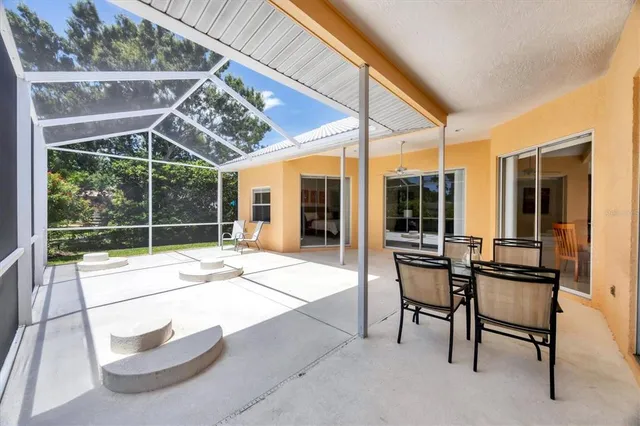 a view of a patio with a table and chairs
