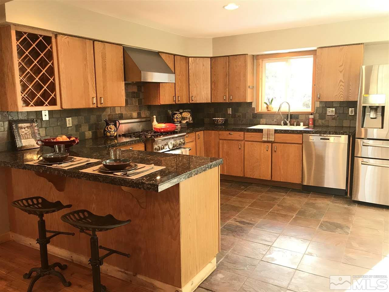 21715 Sazarac Road Reno, NV 89521 - Photo 11 of 25 a kitchen with a sink stove and cabinets
