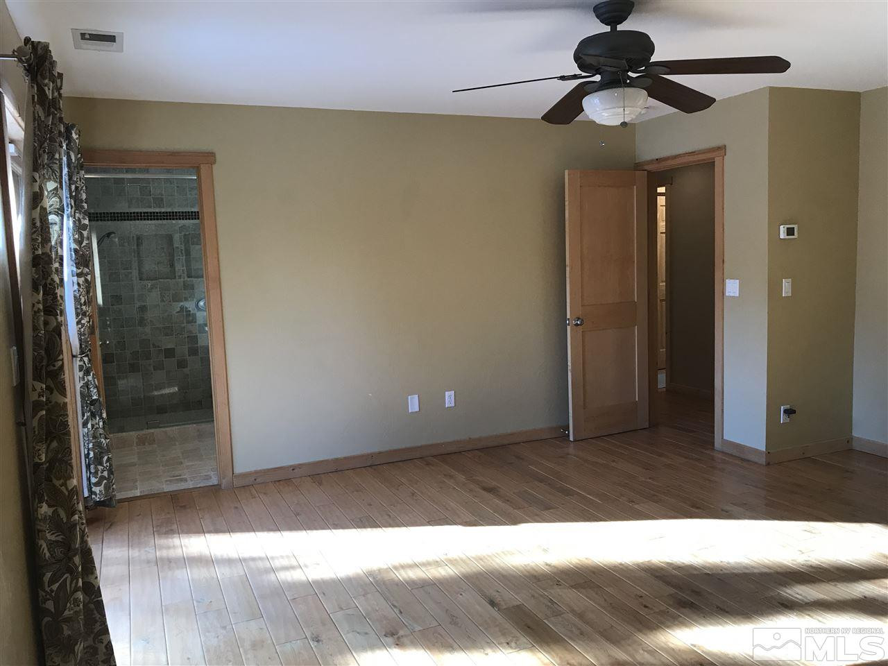 21715 Sazarac Road Reno, NV 89521 - Photo 14 of 25 a view of hallway with a bathroom