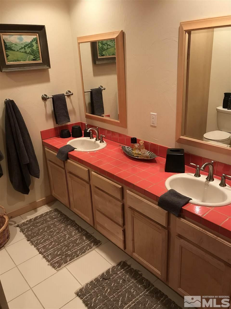 21715 Sazarac Road Reno, NV 89521 - Photo 17 of 25 a bedroom with a bed and a mirror