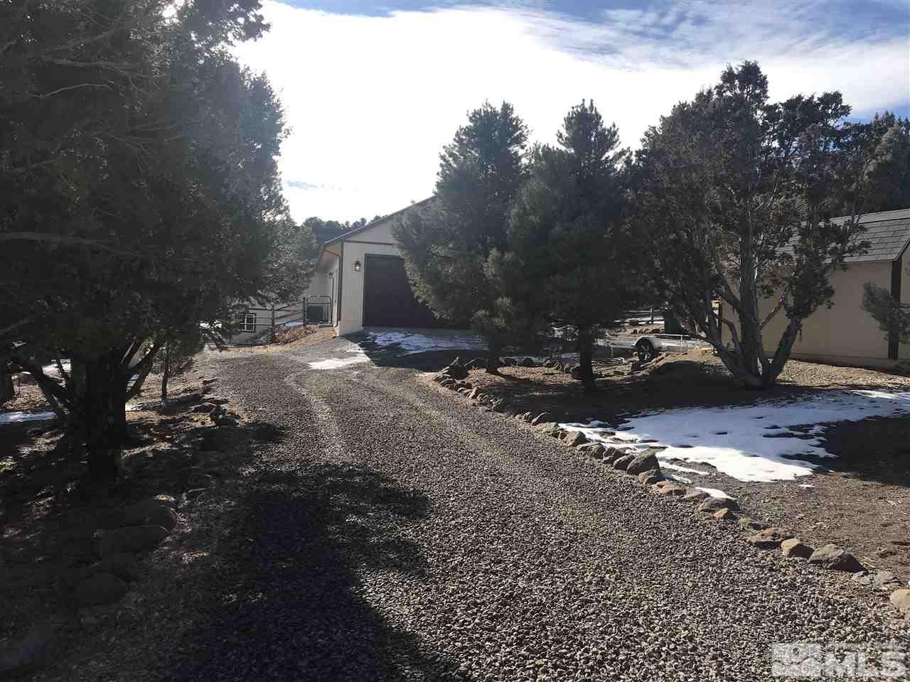 21715 Sazarac Road Reno, NV 89521 - Photo 2 of 25 a view of a dirt road with large trees