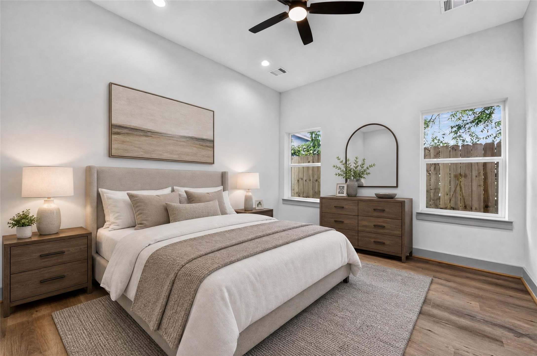6815 Stearns Street Houston, TX 77021 - Photo 5 of 35 Spacious first-floor primary bedroom filled with natural light from generous windows, is a bright, inviting retreat.