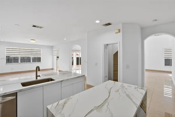 a bedroom with a bed and a view of kitchen