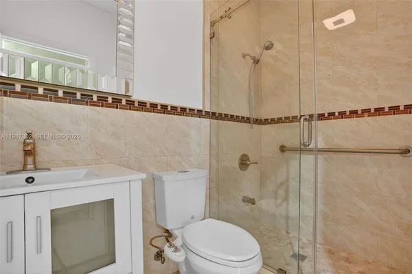 a bathroom with a toilet and a shower