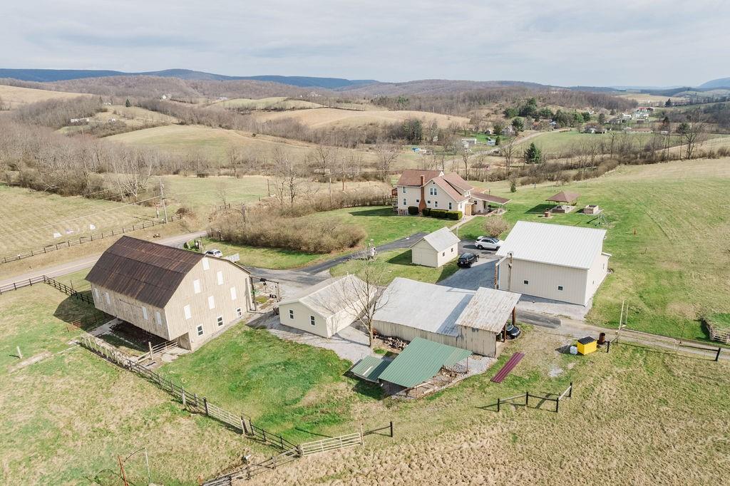 Beautiful Aerial View of Farm with many useable updated outbuildings, barn and home...As peaceful as it looks