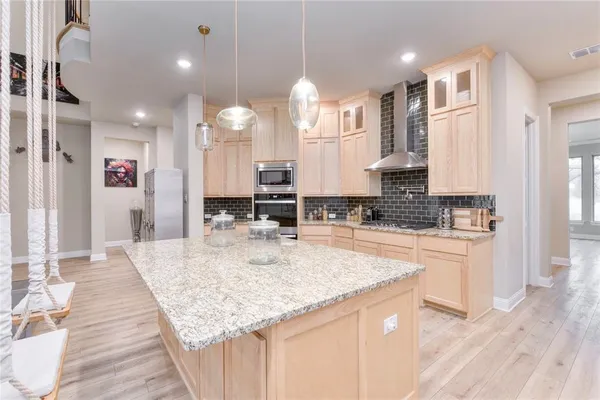 a bedroom with a bed a chair and dresser