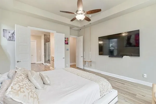 a living room with furniture a flat screen tv and a fireplace