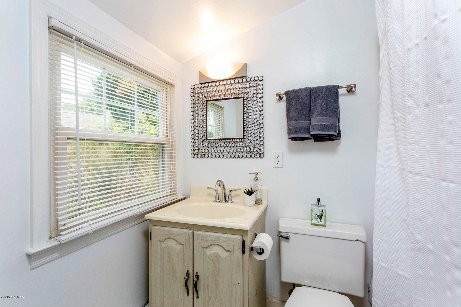37 Meyer Place Riverside, CT 06878 - Photo 18 of 25 a bathroom with a sink a toilet and a window