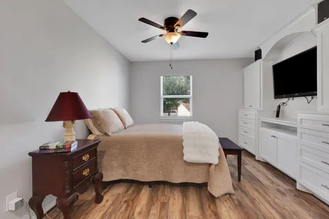 a bedroom with a bed and a flat screen tv