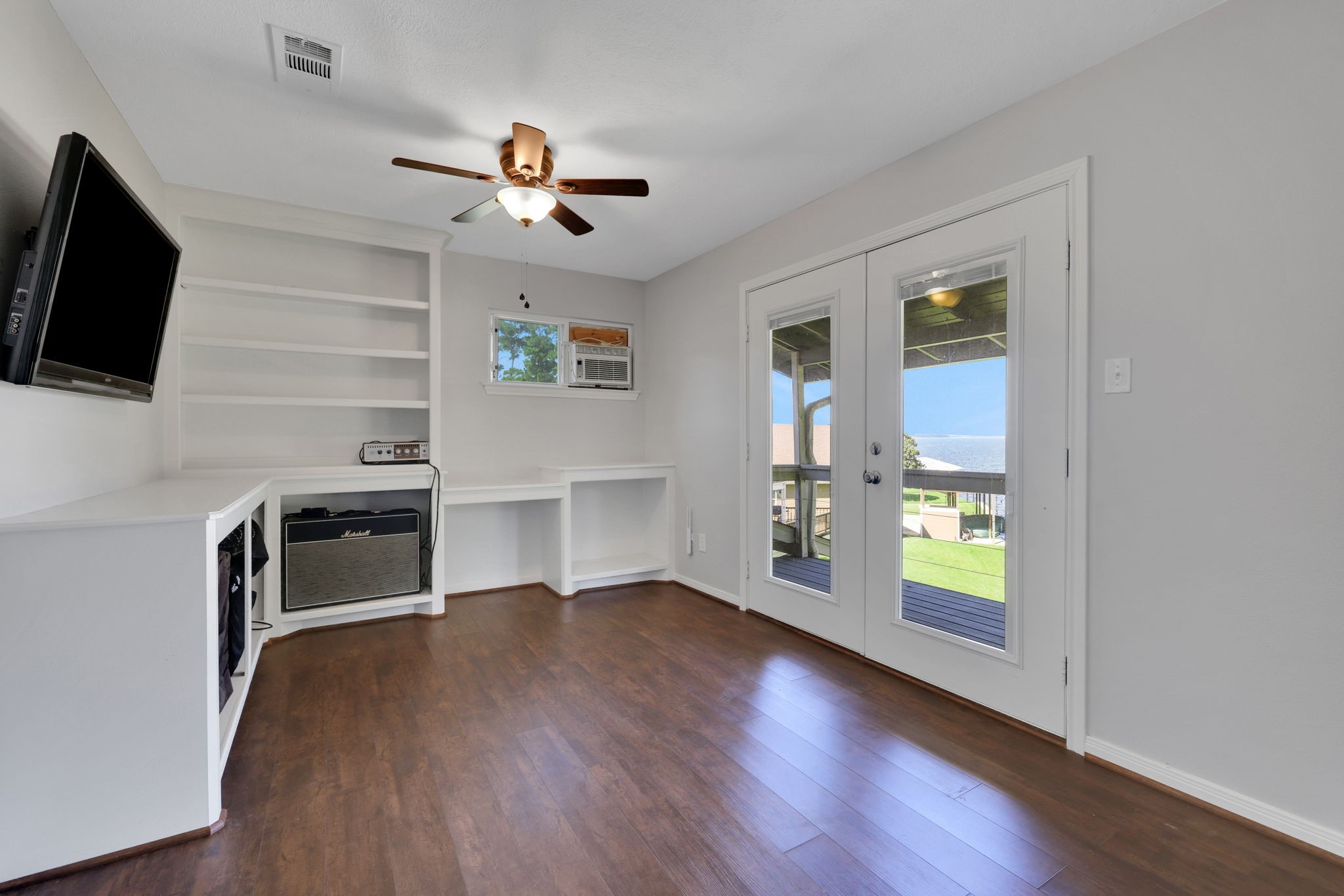 20 Ridgeway Drive Coldspring, TX 77331 - Photo 20 of 40 a view of a livingroom with a flat screen tv wooden floor and a ceiling fan