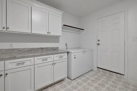 a view of cabinets a sink and dishwasher in a white cabinet