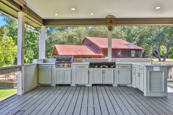 a kitchen with a wooden floor and a large window