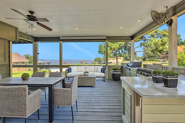 a view of a dining room with furniture large windows and wooden floor