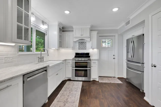 a kitchen with a refrigerator and a sink