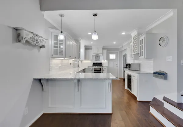 a large kitchen with cabinets and stainless steel appliances