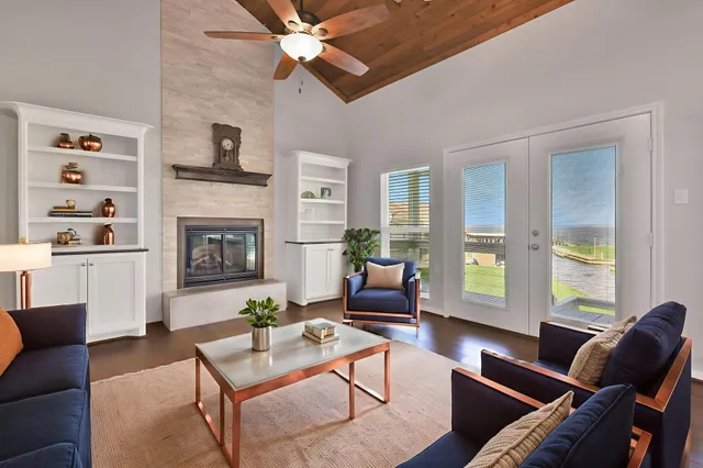 a living room with furniture fireplace and a large window