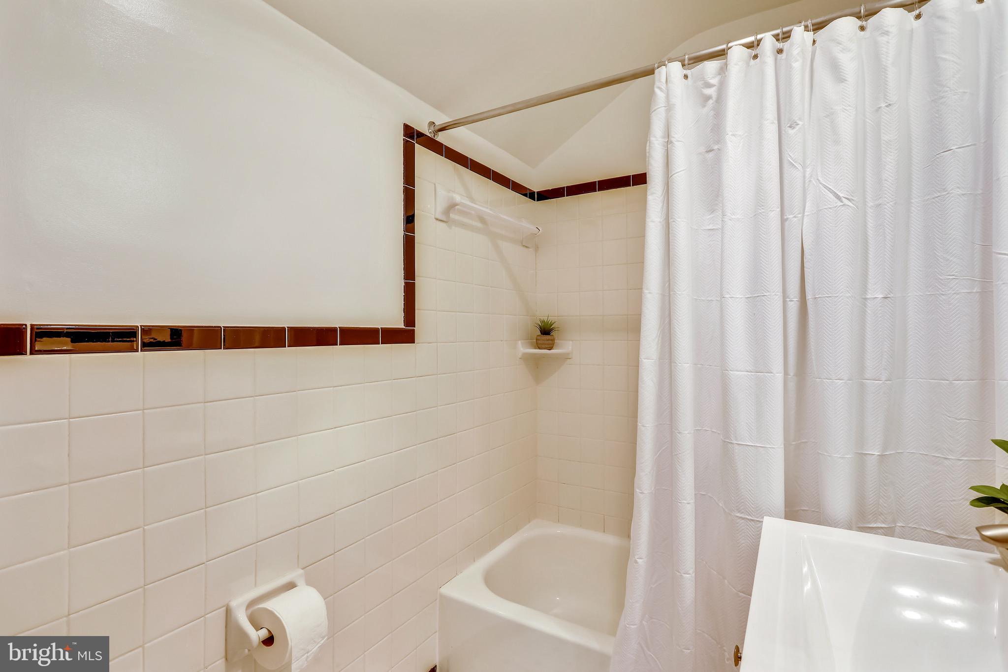 6308 Alcott Road Bethesda, MD 20817 - Photo 24 of 34 2nd level full bath with black and white tile