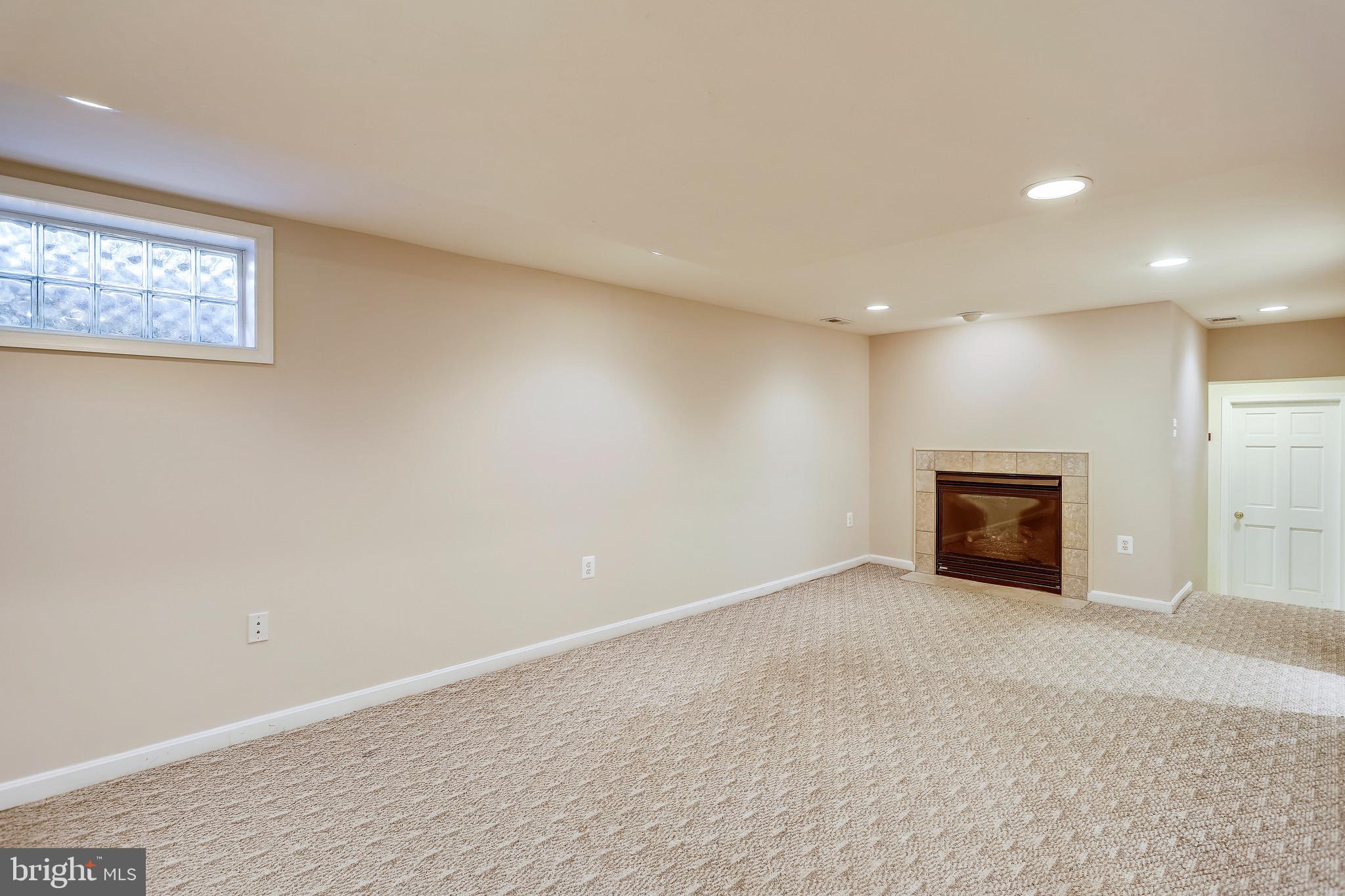 6308 Alcott Road Bethesda, MD 20817 - Photo 25 of 34 Rec room w/ gas FP hallway to 5th BR & full bath