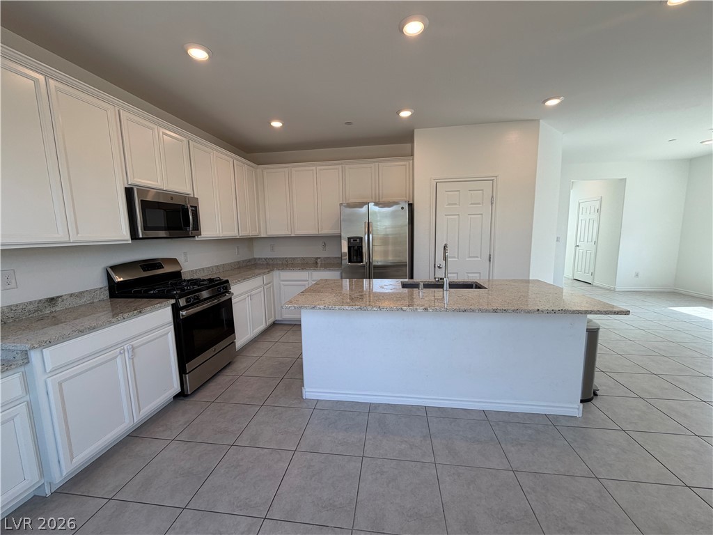 3228 Azalea Ridge Court Henderson, NV 89052 - Photo 4 of 28 Culinary delights await in this bright kitchen with granite counters and a large island.
