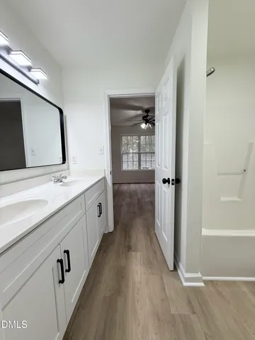 a spacious bathroom with a double vanity sink and mirror