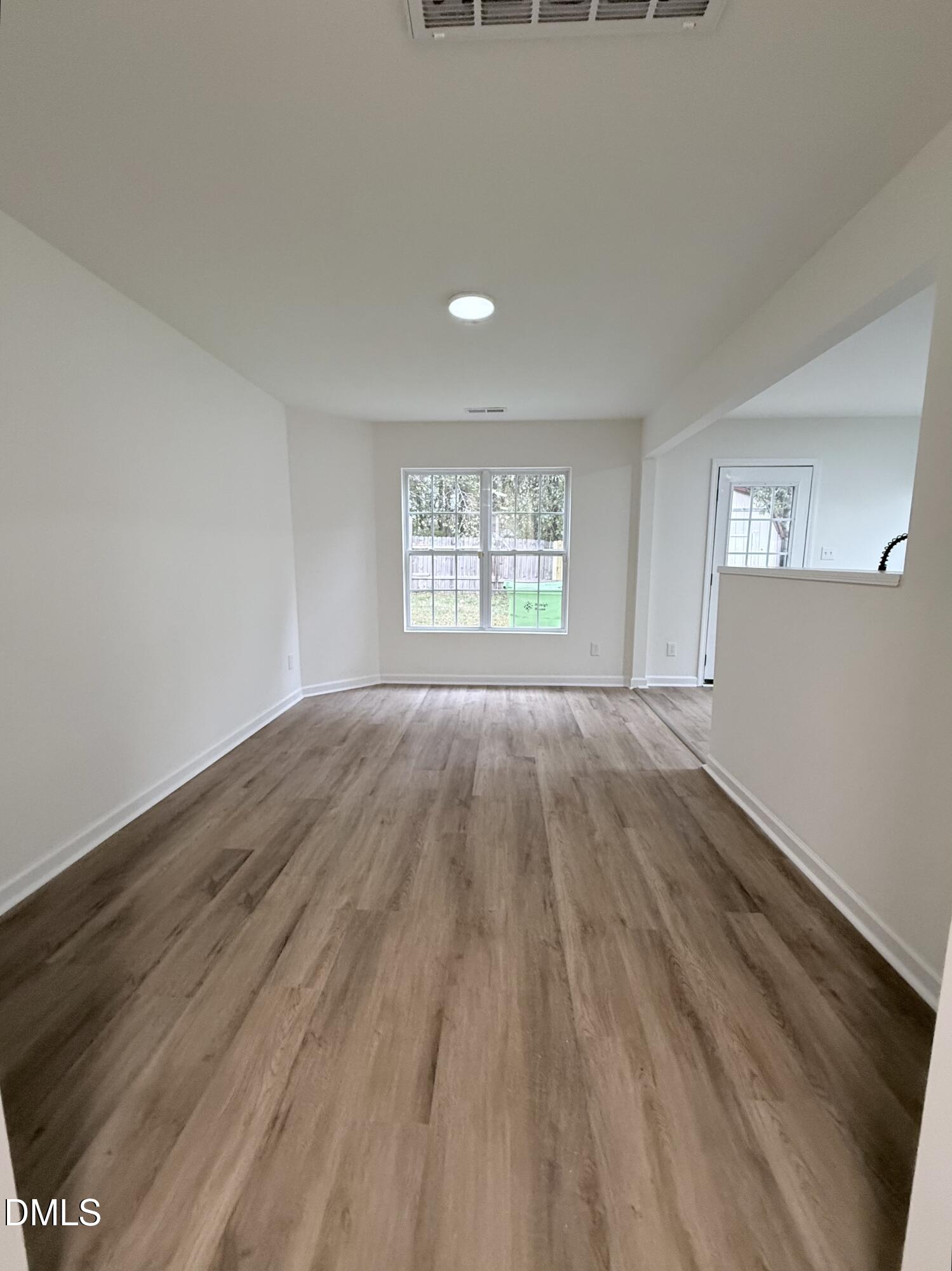4316 Haverty Drive Raleigh, NC 27610 - Photo 3 of 16 an empty room with wooden floor and windows