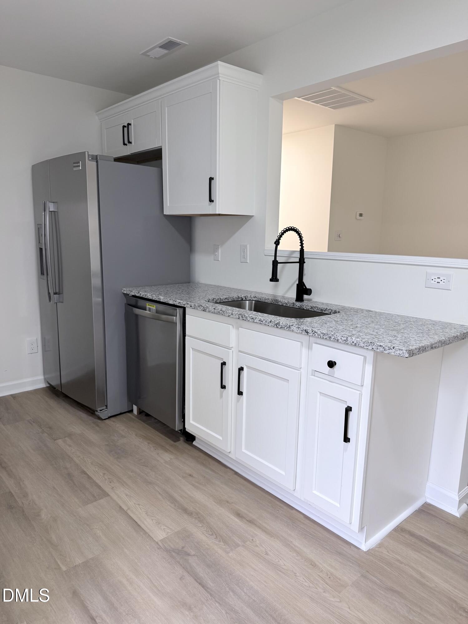 4316 Haverty Drive Raleigh, NC 27610 - Photo 6 of 16 a kitchen with granite countertop white cabinets and stainless steel appliances