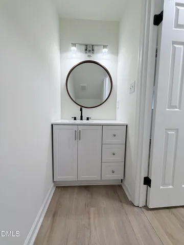 a view of a room with a mirror and a sink