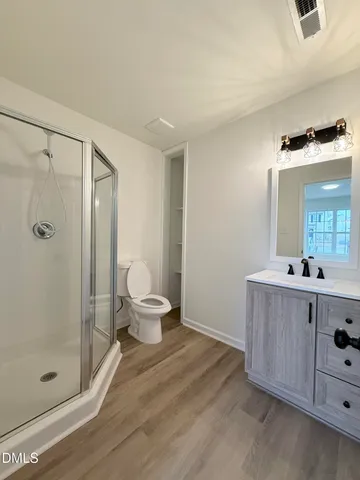 a bathroom with a shower sink and mirror