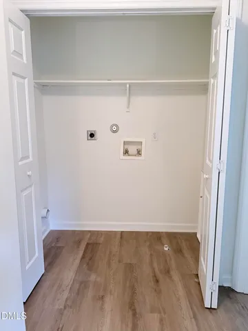 a view of walk in closet with wooden floor