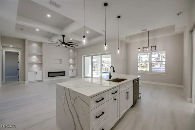 a kitchen with stainless steel appliances granite countertop a sink and a refrigerator