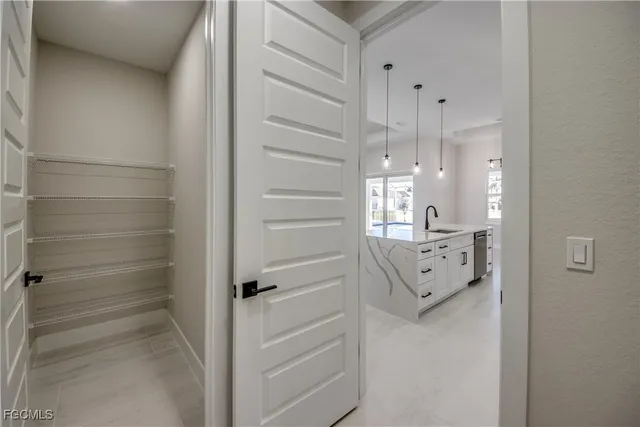 a bathroom with white cabinets