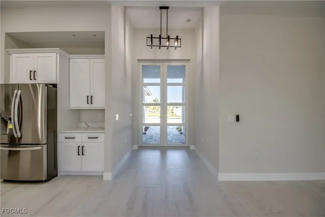 a kitchen with a refrigerator and a stove top oven