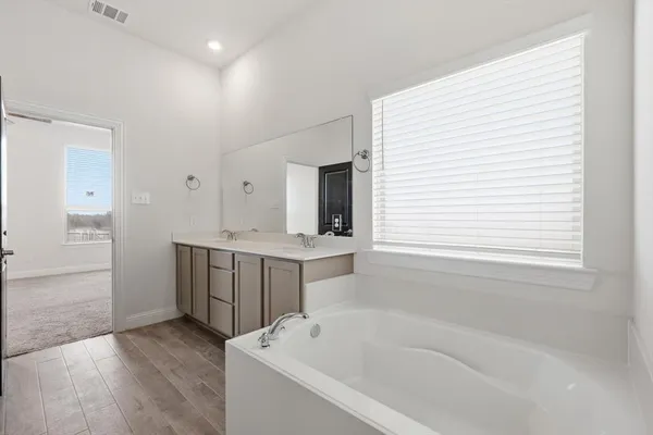 a bathroom with a bathtub and a sink